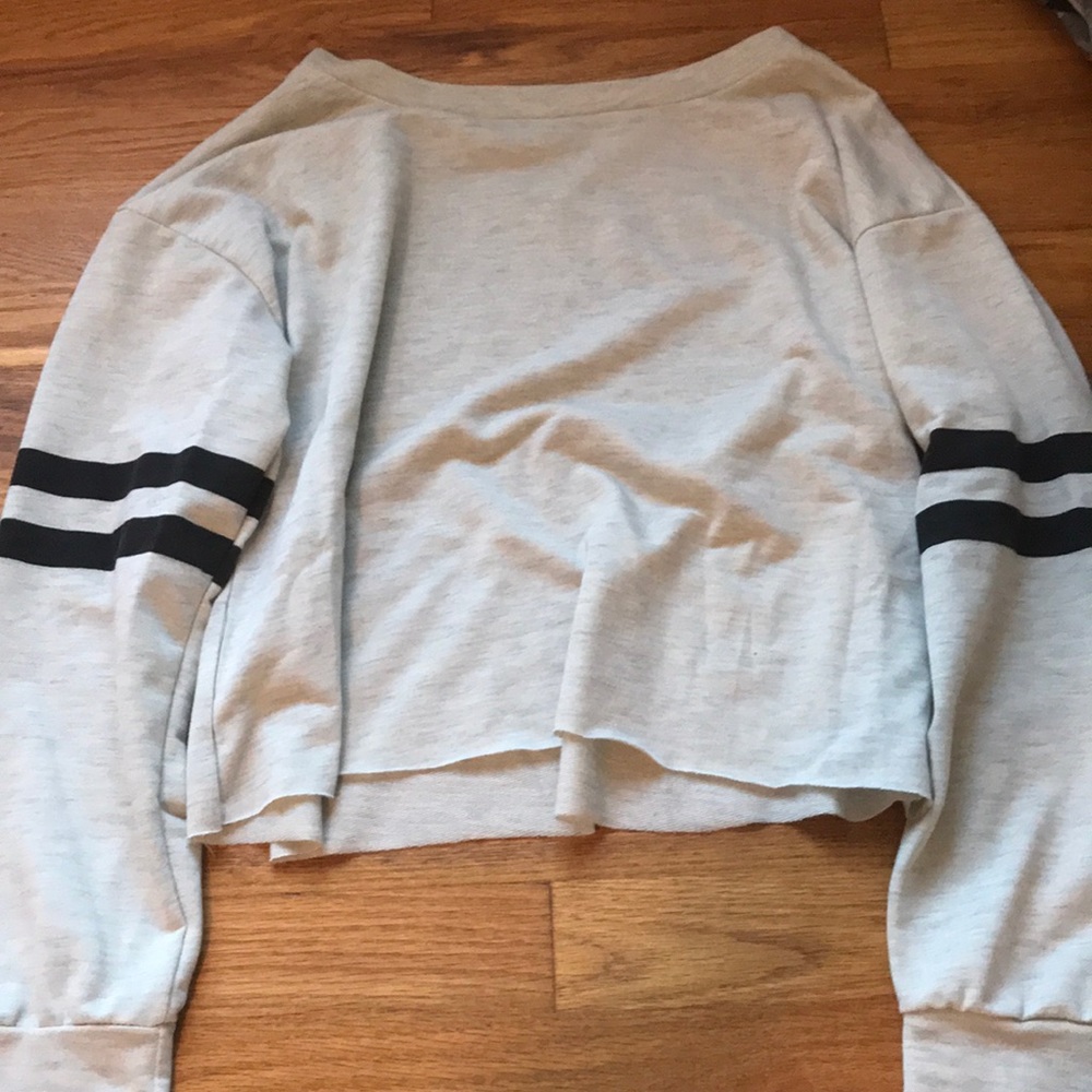 Grey long sleeve with blue stripes on sleeves